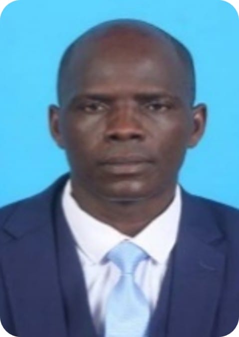 A man in a blue suit and light blue tie poses for a formal portrait against a solid blue background, embodying professionalism reminiscent of an ecophysiology or crop modelling expert.